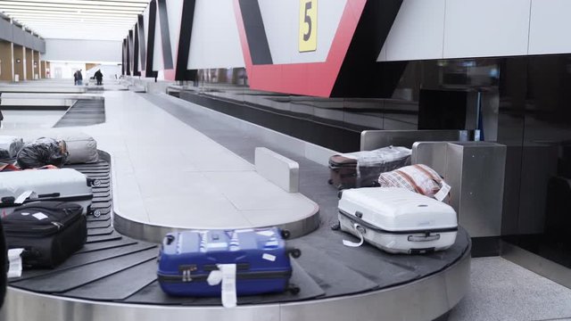 Luggage on a conveyor belt in the baggage claim area of international airport
