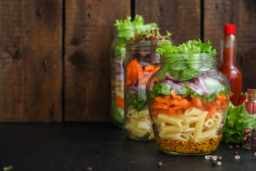 healthy salad in a jar (vegetable snack pasta salad) menu concept. food background. top view. copy space