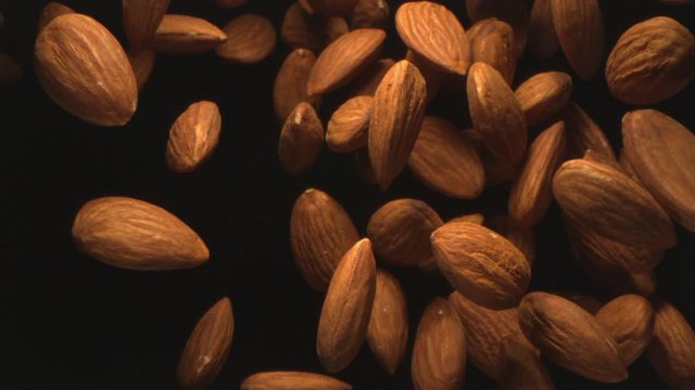 Almond Nuts Flying in the Air in a Free Fall in Slow Motion on Black Background at 1500 fps  4K