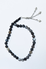 Handmade rosary necklace made of beads, black agate and silver on white Background	