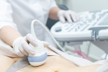Gynecologist doing ultrasound scan in modern clinic - obrazy, fototapety, plakaty