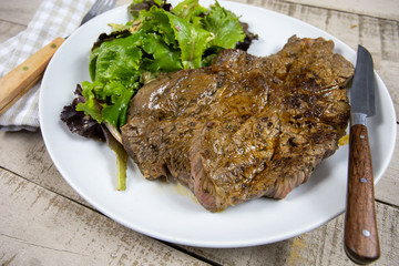 grilled prime rib and salad on a plate