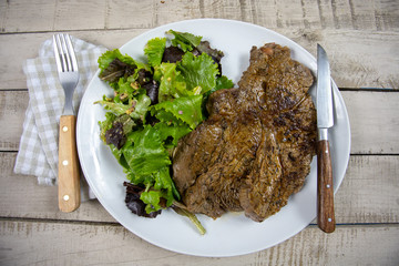 grilled prime rib and salad on a plate