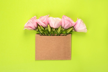 Eustoma flower arrangement with flowers and blank card, on green background