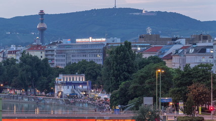 Aerial view along the Danube Canal in Vienna day to night timelapse after sunset