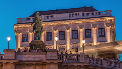 Fototapeta na wymiar Night view of equestrian statue of Archduke Albert in front of the Albertina Museum day to night timelapse in Vienna, Austria