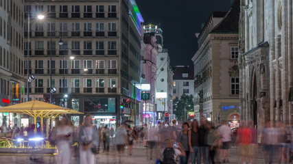 Fototapeta na wymiar People walking in the Old city center of Vienna in Stephansplatz night timelapse