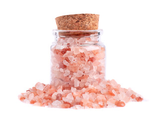 Himalayan pink salt in glass jar, isolated on white background. Himalayan pink salt in crystals.