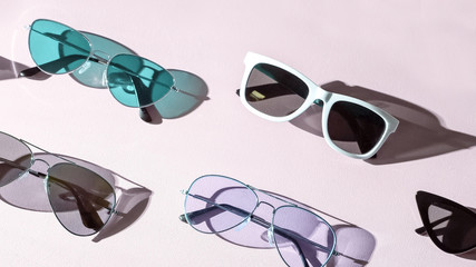 Variety of sunglasses over colorful background