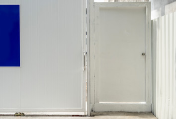 White door with warehouse closeup and shadow