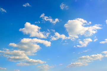 Cumulus clouds in the blue sky .