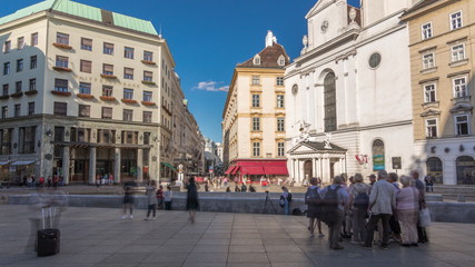 Fototapeta premium St. Michael's Church timelapse hyperlapse at Michaelerplatz from St. Michael's Gate of Hofburg