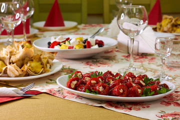 Rolls from bell red pepper with soft cheese on the plate