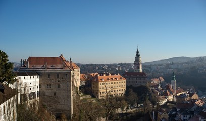 Fototapeta na wymiar Castle tower and church in historical town Cesky Krumlov listed in UNESCO cultural heritage.