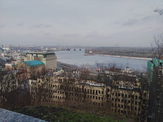 aerial view of the city of Kiev with Dnieper river, cloudy weather, Podilsky bridge visible
