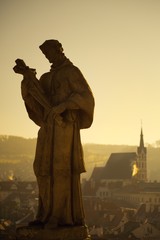Fototapeta premium Castle tower and church in historical town Cesky Krumlov listed in UNESCO cultural heritage.