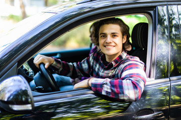 Portrait of an attractive couple driving a car and about to go on a trip