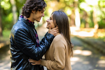 Young pretty couple kissing each other on the street