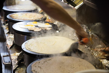 French chef cooking traditional galette in Rennes ,France.