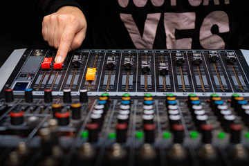 Woman hands mixing audio by sound mixer analog