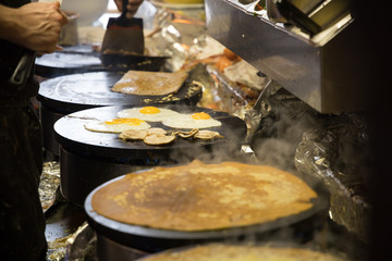 French chef cooking traditional galette in Rennes ,France.
