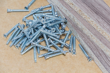 Screw-on for furniture. Metal screw. Vertical. Metal screws. Furniture fittings and fittings. Stainless steel. Realistic.