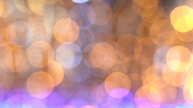 Festive golden elegant abstract video bokeh background of defocused holiday led lights. Real time 4k video footage.