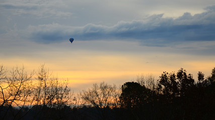 Hot Air Balloon at Dawn on Winter Day in the Blue Ridge Mountains with colorful sky & clouds.