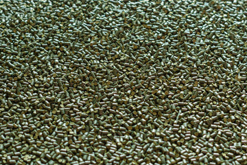 Green polymer dye in granules, background texture