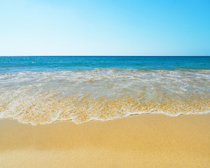 Fototapeta na wymiar Waves on the beach as a background
