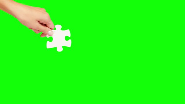 Hands solving a puzzle. 8 videos in one file. Female and male hands solving a blank puzzle. Green Screen. More options in my portfolio.   