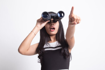 Young Asian woman  point and look with binoculars.