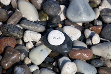Words on pebble stones – motivational concept slogan – word travel