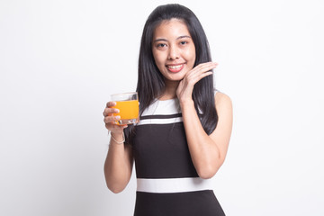 Happy Young Asian woman drink orange juice.