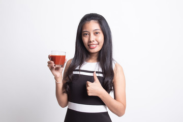 Young Asian woman thumbs up with tomato juice.