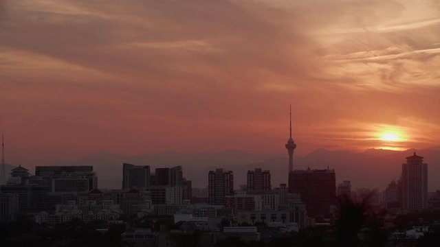 Panoramic view of impressive sunset, Central Radio & TV Tower, skyscrapers and buildings in Beijing