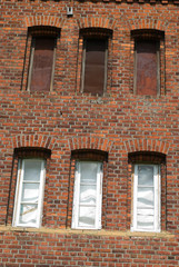Detail of the historical building - former train station. Authentic masonry brickwall, windows and other details