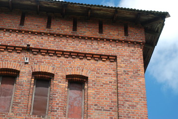 Detail of the historical building - former train station. Authentic masonry brickwall, roof and other details