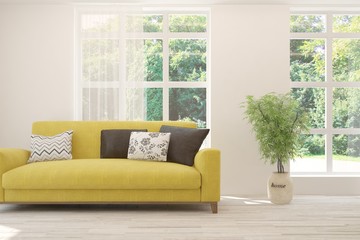Stylish room in white color with yellow sofa and summer landscape in window. Scandinavian interior design. 3D illustration