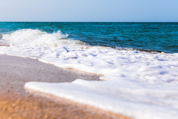Foamy surf on a sandy tropical beach