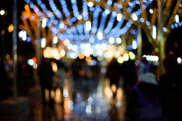 Christmas defocused street background. Texture of the city christmas lights.