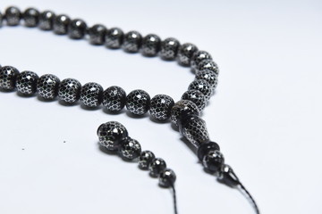 Handmade rosary necklace made of beads, black agate and silver on white Background	