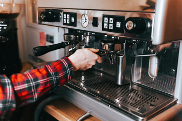 Barista makes aromatic coffee. Process of making latte coffee on a coffee machine in a cafe