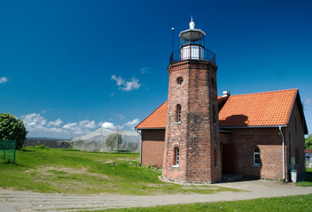 Old historical lighthouse on the shoreline of the sea