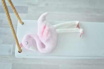 pink toy flamingo on rope swing