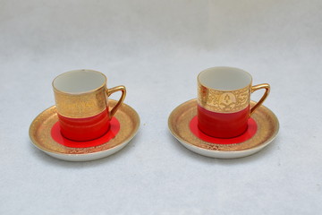 Mock up / design set of elegant and traditional colorful Red and gold traditional elegant coffee cup & Tea cup on cup's plate , template for branding identity and company logo design/ drink-ware