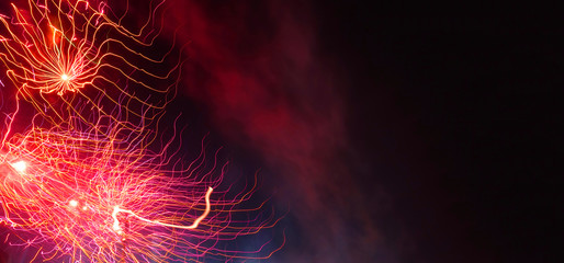 Ultra wide panoramic night shot of beautiful slow shutter fireworks as seen during festive...