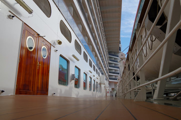 Open deck on boat deck promenade outside of modern luxury MSC Cruises cruise ship liner with life...