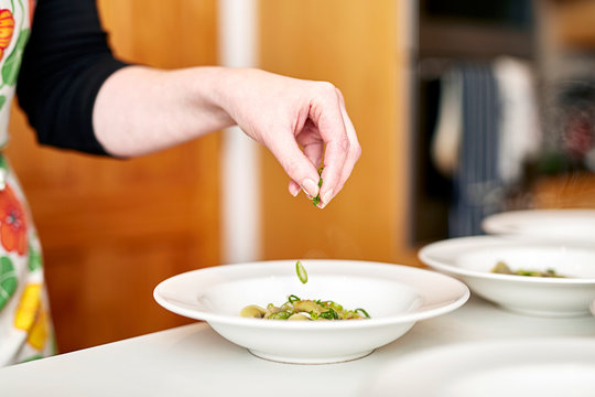Dish being garnished by hand