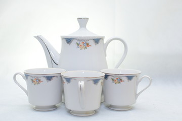 Mock up / design set of elegant and traditional teapot colorful white and blue coffee cup & Tea cup on cup's plate beside the hot tea pot , design/ drink-ware isolated on white background